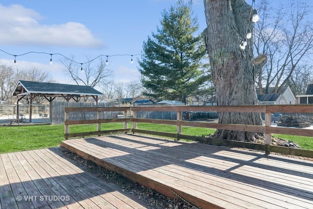 wooden terrace with a gazebo and a yard