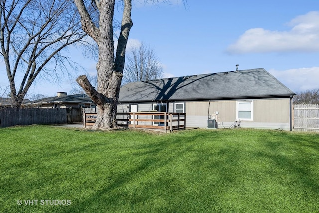 rear view of house with a yard