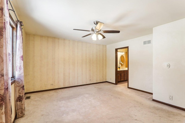 carpeted spare room with ceiling fan