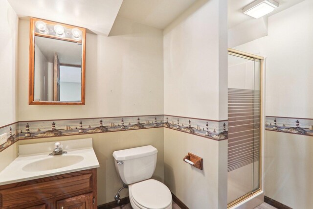 bathroom with vanity, an enclosed shower, and toilet