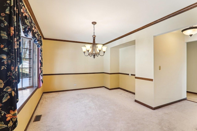 carpeted spare room featuring crown molding and a chandelier