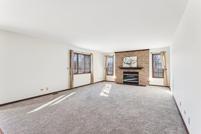 unfurnished living room featuring a fireplace and carpet floors