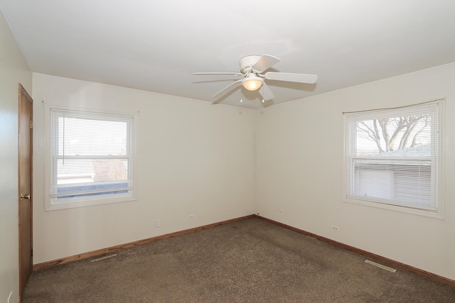 carpeted spare room featuring ceiling fan