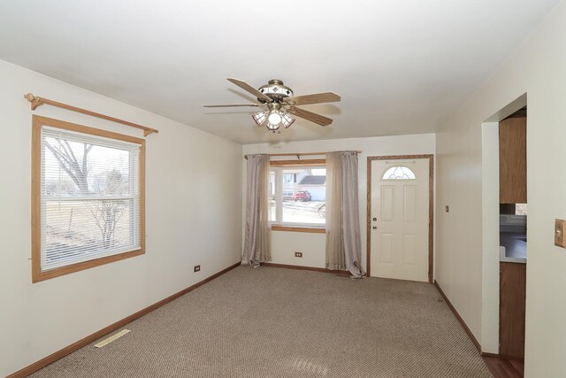 empty room featuring carpet flooring and ceiling fan