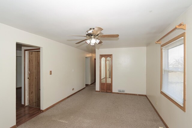 empty room with ceiling fan and dark hardwood / wood-style flooring