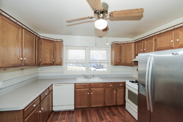 kitchen with sink, white appliances, dark wood-type flooring, and ceiling fan