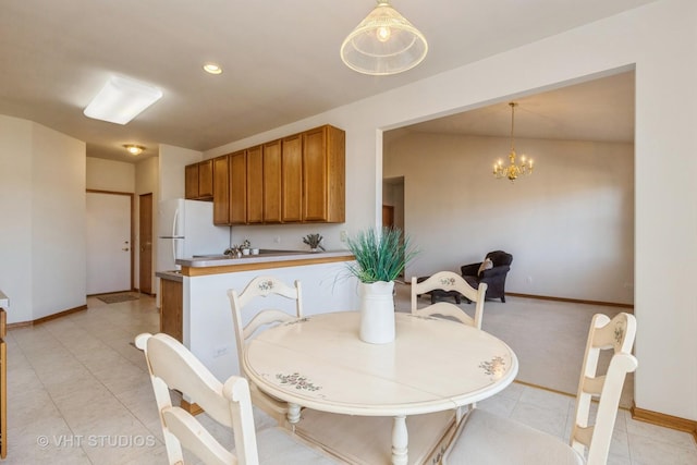 dining space with a notable chandelier and light tile patterned floors