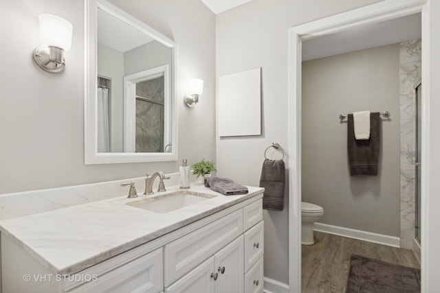 bathroom with wood-type flooring, a shower, vanity, and toilet