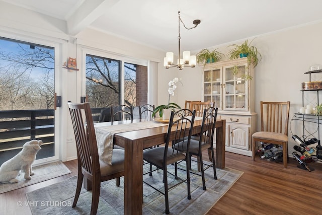 dining space with an inviting chandelier, dark hardwood / wood-style floors, and beamed ceiling