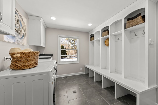 mudroom featuring dark tile patterned floors and independent washer and dryer