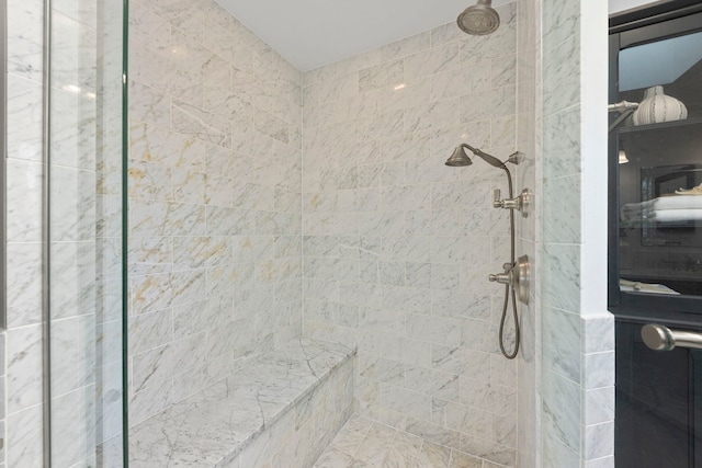 interior details featuring a tile shower