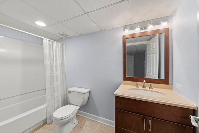 full bathroom with shower / tub combo, vanity, toilet, and a drop ceiling