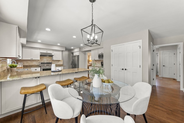 dining room featuring dark hardwood / wood-style floors and sink