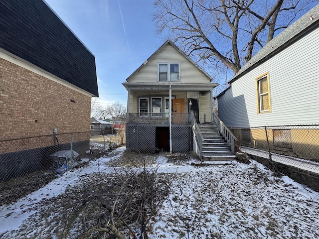 snow covered property featuring covered porch