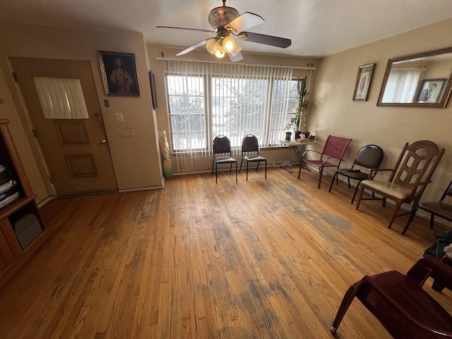 sitting room with hardwood / wood-style flooring and ceiling fan