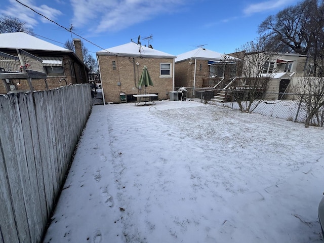 yard covered in snow with cooling unit