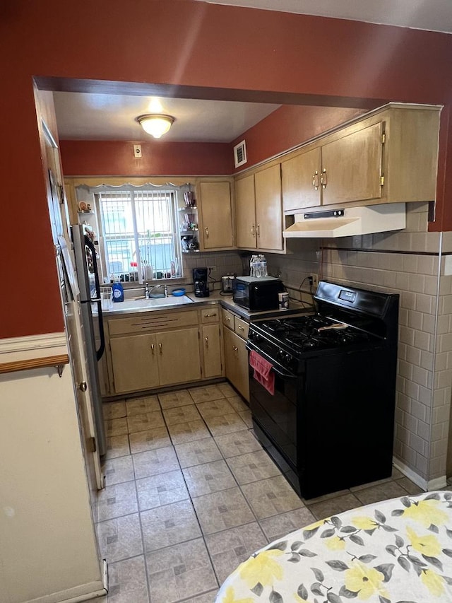 kitchen with sink, backsplash, and black appliances