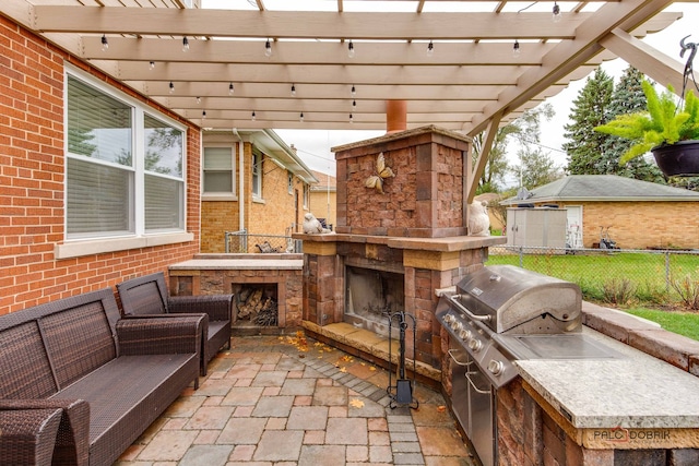 view of patio / terrace featuring an outdoor kitchen, an outdoor stone fireplace, and a pergola