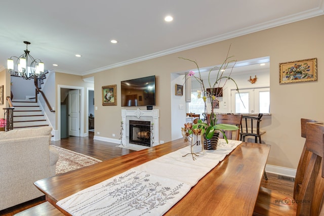 dining space featuring crown molding and dark wood-type flooring