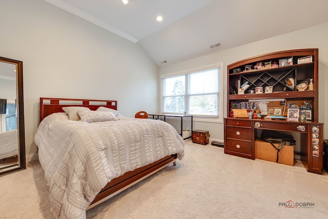 carpeted bedroom with crown molding and vaulted ceiling