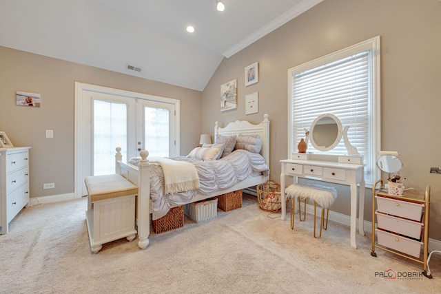 carpeted bedroom with french doors, access to exterior, and vaulted ceiling