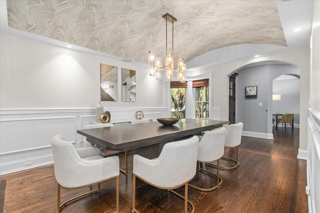 1210 Blackthorn Ln, Deerfield, IL 60015 - dining area featuring arched walkways, a chandelier, lofted ceiling, dark wood finished floors, and wainscoting