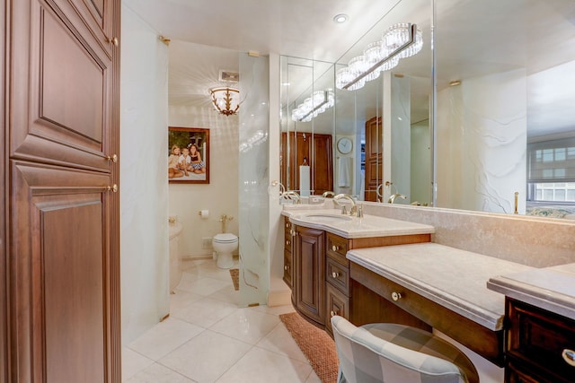 bathroom featuring tile patterned floors, toilet, and vanity