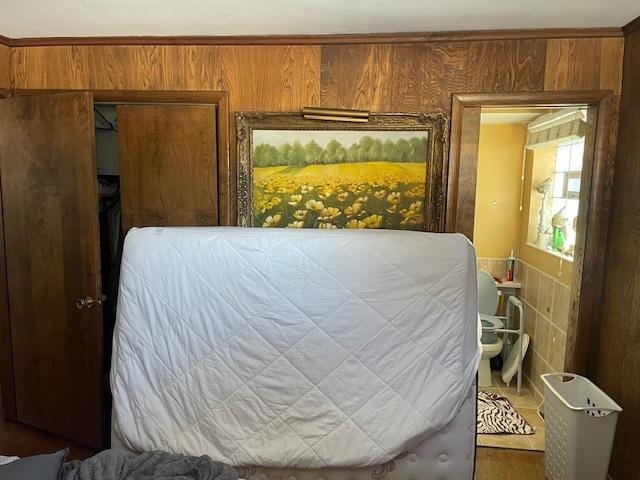 bedroom with wooden walls and a closet