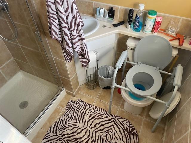 bathroom with walk in shower, tile patterned floors, and toilet