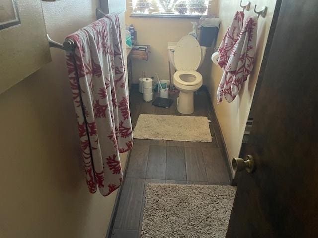 bathroom with curtained shower and toilet