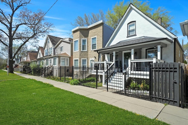 view of front facade with a front yard and covered porch