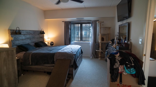 carpeted bedroom with a textured ceiling and ceiling fan