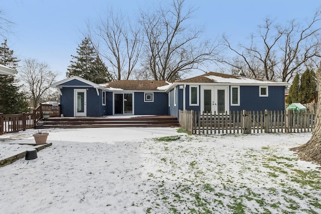 snow covered property featuring french doors