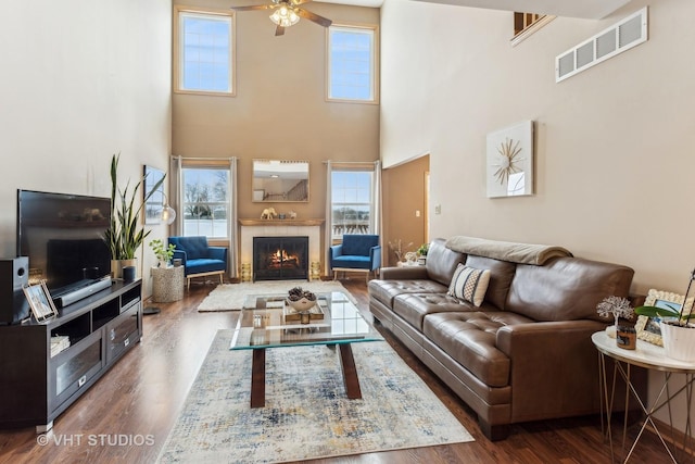 living room with dark hardwood / wood-style floors and ceiling fan