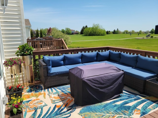 deck with an outdoor living space and a yard