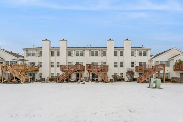 view of snow covered rear of property