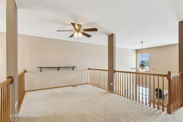 unfurnished room with ceiling fan and carpet flooring