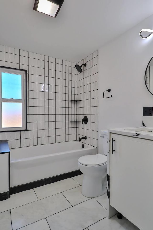 full bathroom featuring tiled shower / bath combo, vanity, tile patterned flooring, and toilet