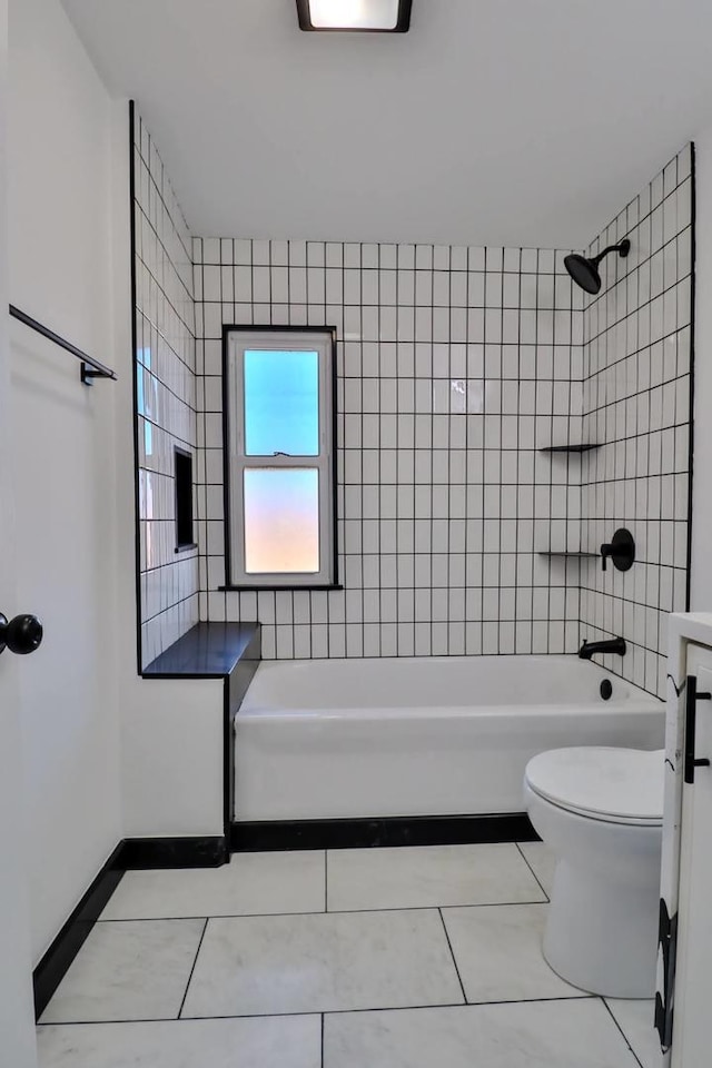 full bathroom featuring tile patterned floors, toilet, tiled shower / bath combo, and vanity