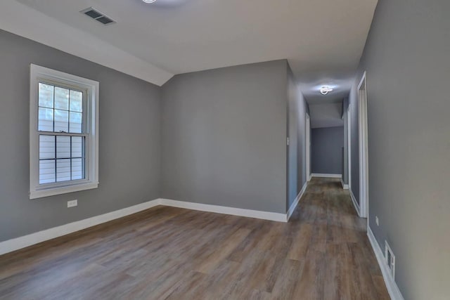 additional living space with lofted ceiling and wood-type flooring