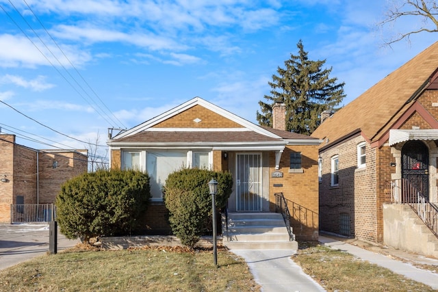 bungalow with a front lawn