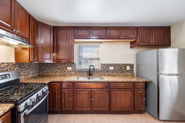 kitchen with tasteful backsplash, stainless steel appliances, sink, and light stone counters