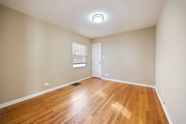 spare room with hardwood / wood-style flooring