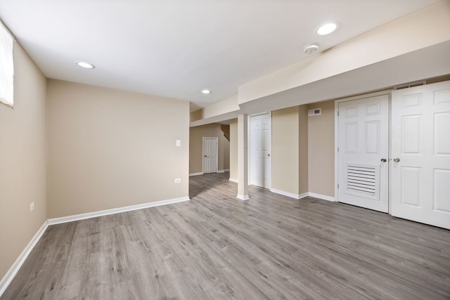 basement with hardwood / wood-style flooring