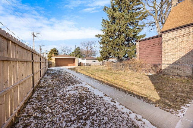 view of yard with a garage and an outbuilding