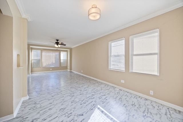 unfurnished room featuring ceiling fan and ornamental molding