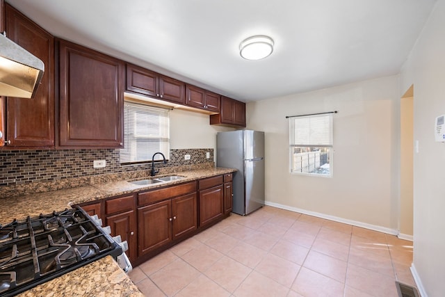 kitchen with sink, backsplash, a wealth of natural light, and stainless steel appliances