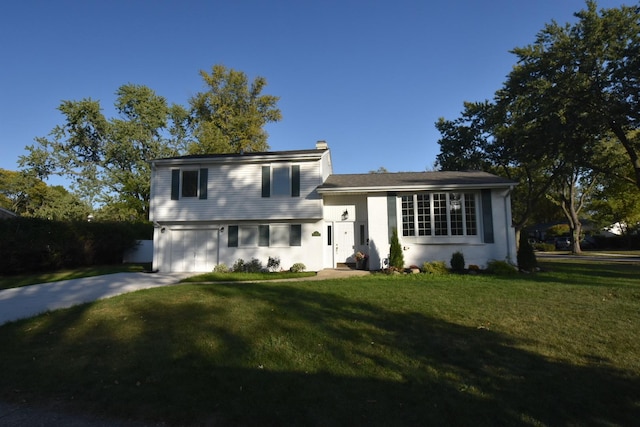 split level home with a garage and a front lawn