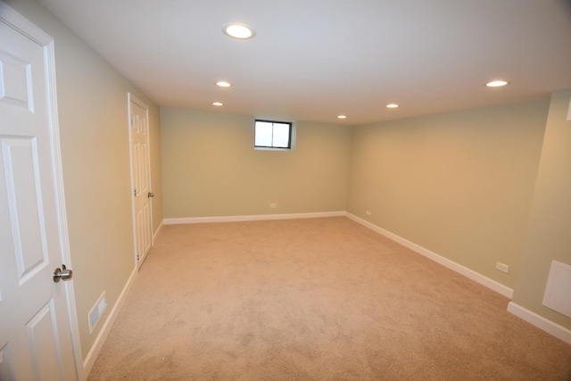 basement featuring light carpet