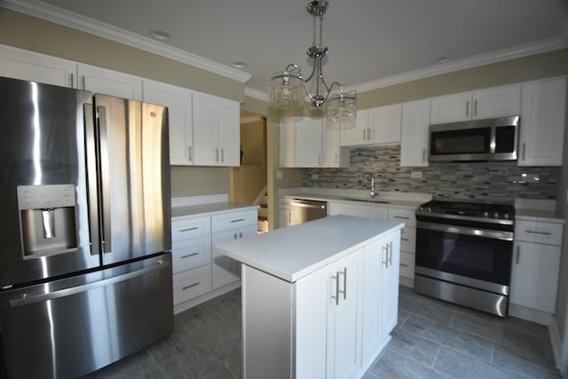 kitchen featuring sink, white cabinetry, hanging light fixtures, a kitchen island, and stainless steel appliances